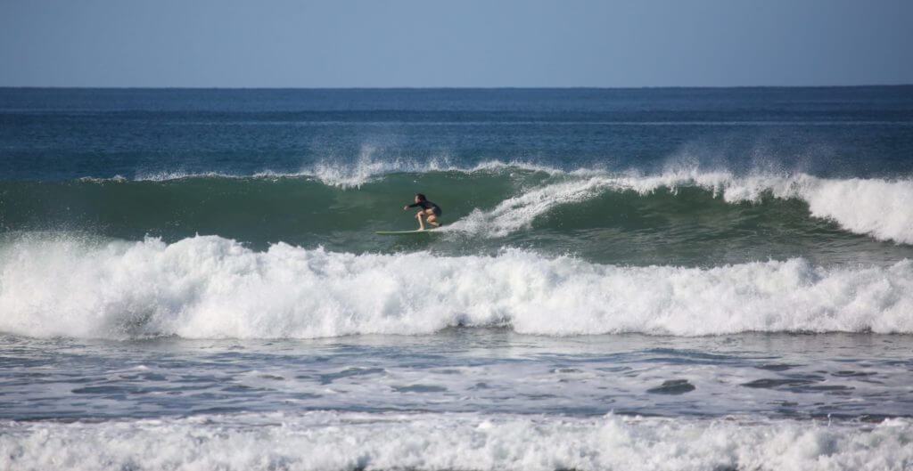 surfer riding a crashing wave